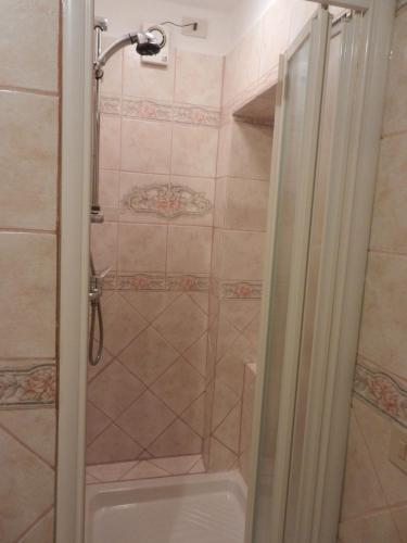 a shower with a glass door in a bathroom at PietraMilia in Terricciola