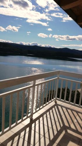 a balcony with a view of a body of water at Apartmani Leženić Dada in Neum