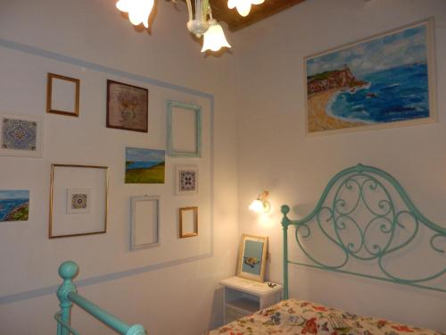 a bedroom with a bed and pictures on the wall at PietraMilia in Terricciola