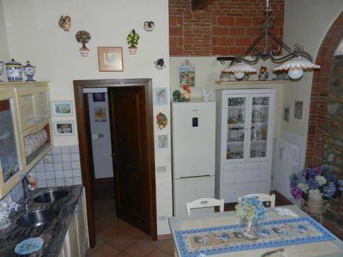 a kitchen with a sink and a refrigerator at PietraMilia in Terricciola