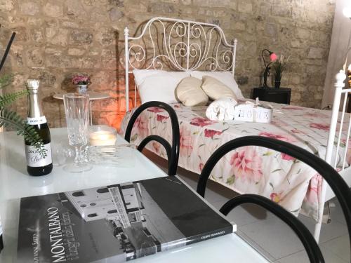 a bedroom with a bed with a table with a laptop at Stella del centro in Modica