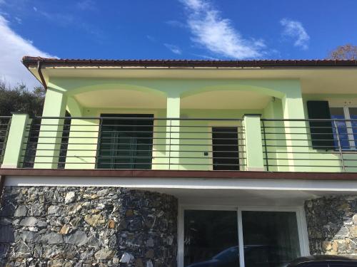 a house with a balcony on top of it at VILLA DEGLI ULIVI in Chiavari