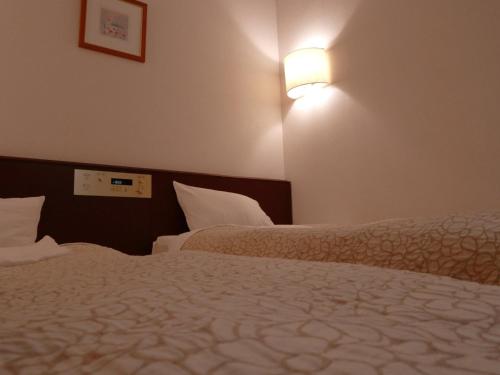 Ένα ή περισσότερα κρεβάτια σε δωμάτιο στο Kuretake-Inn Central Hamamatsu