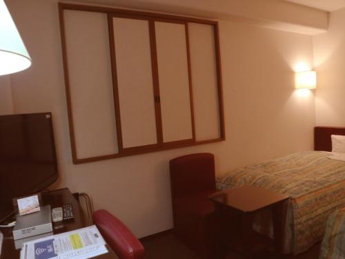 Ένα ή περισσότερα κρεβάτια σε δωμάτιο στο Kuretake-Inn Central Hamamatsu
