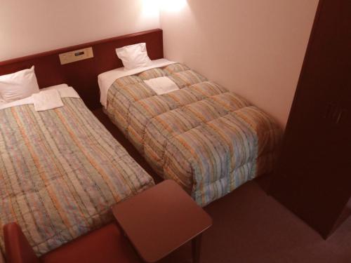 Ένα ή περισσότερα κρεβάτια σε δωμάτιο στο Kuretake-Inn Central Hamamatsu