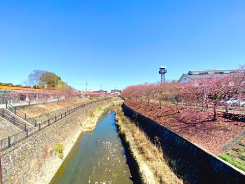 a canal of water with trees on the side at White Space in Kakegawa