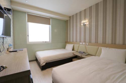 Una cama o camas en una habitación de Chao She Hotel