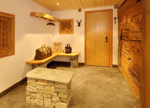 a room with a stone bench and a wooden door at Ferienapartement Hinterdorf in Zermatt