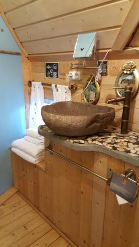 a bathroom with a stone sink on a counter at Le Bassin du Tertre in Fronsac
