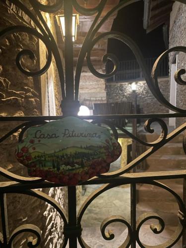a wrought iron gate with a sign on it at Independent Stone House with Lake View in Musso