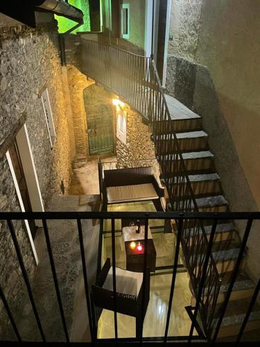 an overhead view of a staircase with a chair and a table at Independent Stone House with Lake View in Musso