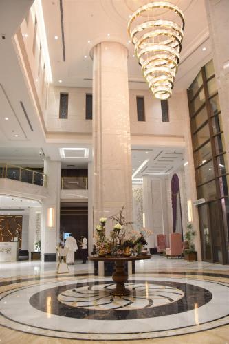 a large lobby with a large chandelier in a building at Midan Hotel & Suites Al Aziziya in Makkah