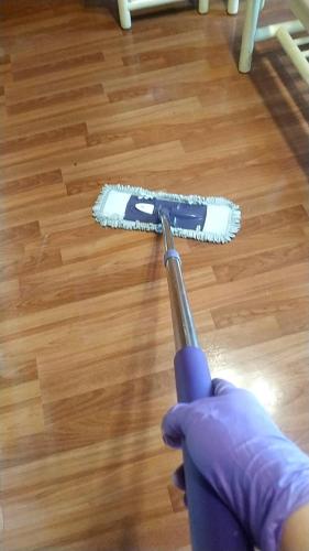 a person in purple rubber gloves holding a brush at Master Bear Resort in Jiafeng
