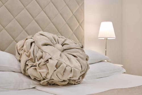 a large blanket on a bed with a lamp at Best location Rooms in Split