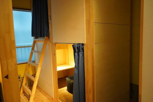 Ένα ή περισσότερα κρεβάτια σε δωμάτιο στο Konyamachi Guest House Kuku