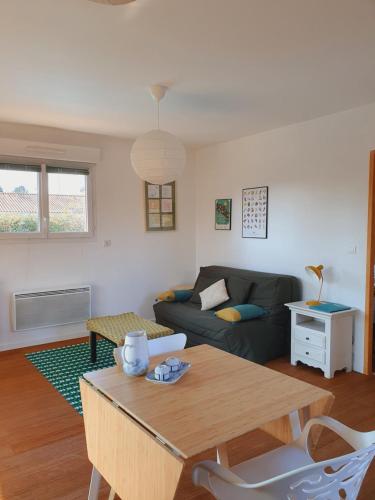 un salon avec un canapé et une table dans l'établissement Au calme, entre lac et océan, à Vielle-Saint-Girons