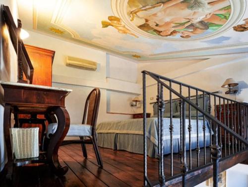 a room with a piano and a bed with a ceiling at B&B Locanda San Michele in Corciano