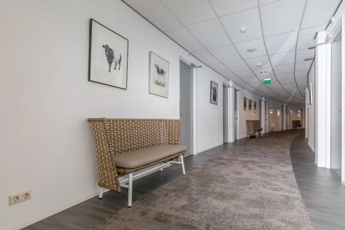 a hallway with a bench in a building at Resort Land & Zee in Scharendijke