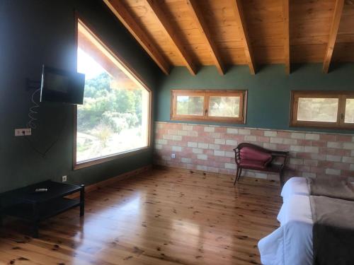 a living room with a couch and a window at MASIA MAS DE LA CREU in Valderrobres