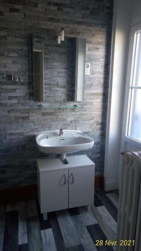 une salle de bain avec un lavabo et un miroir dans l'établissement Montplaisir, à Montendre