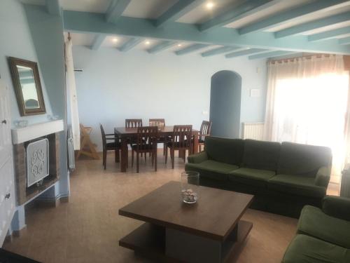 a living room with a couch and a table at Amazing in front of the sea apartment in Comarruga
