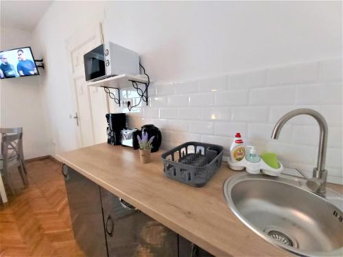a kitchen counter top with a sink and a sink at 92 Residence in Braşov