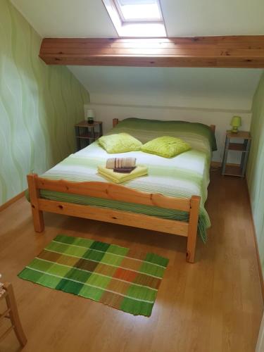 a bedroom with a bed with a skylight at Chambres d'Hôtes Vadiera in Autun