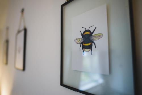 a picture of a bee in a mirror at Hectors house in Ormesby Saint Michael
