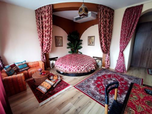 a living room with a bed and a couch at Hotel Africa in Haskovo