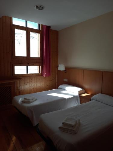 Cama o camas de una habitación en Hostal Pico Agujas