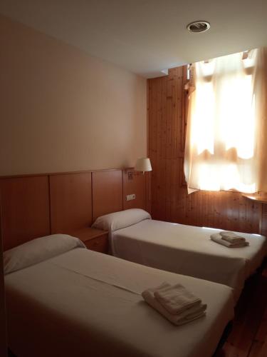 Cama o camas de una habitación en Hostal Pico Agujas