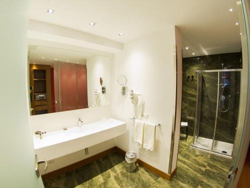 a bathroom with a sink and a shower at Catania International Airport Hotel in Catania