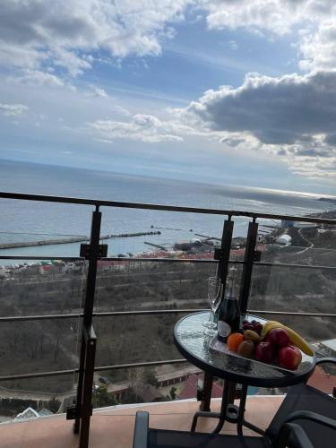 a plate of fruit on a table on a balcony at Arcadia apartment & sea terrace in Odesa