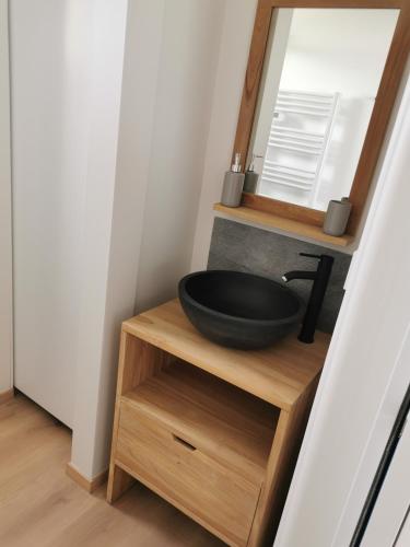 a bathroom with a black sink and a mirror at Perle d'Opale T2 FACE MER BALNÉO-SPA PARKING PRIVÉ WIFI NETFLIX HÔTEL&LOGDE 4 PERS in Berck-sur-Mer