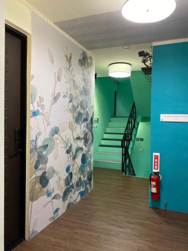 a hallway with a mural of flowers on the wall at Teacher Cai Homeestay in Xiaoliuqiu