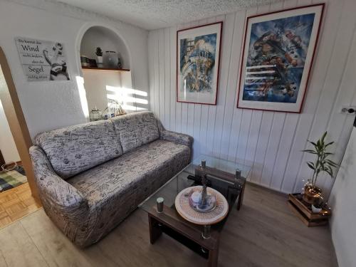 a living room with a couch and a table at Bungalow bei Warnemünde in Elmenhorst
