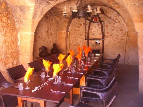 a long table in a room with chairs around it at Finca Can Rotger in Caʼs Concos