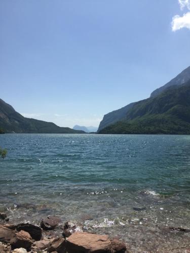 a large body of water with mountains in the background at Hotel Fontanella in Molveno