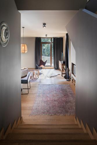 a room with a living room with a couch and a rug at Borovets Chalets in Borovets