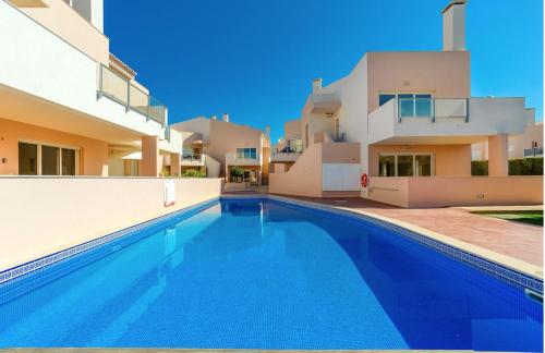 a swimming pool in front of a house at Casa Laranja, Aromas Burgau in Burgau