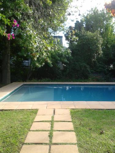 a swimming pool in a yard with grass and trees at Sunny Lane in Franschhoek