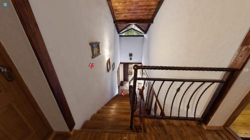 a hallway with a stairway with a wooden stair railing at Chalet Vedmezhe in Polyana