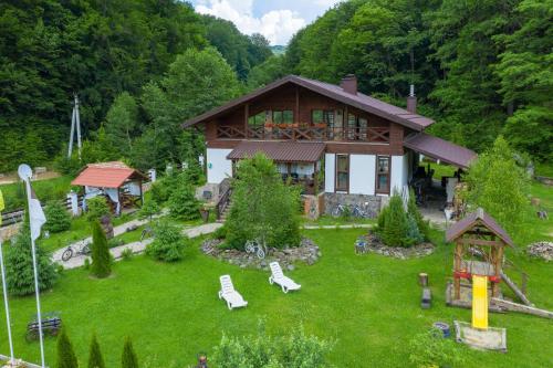 a house with a garden in front of it at Chalet Vedmezhe in Polyana