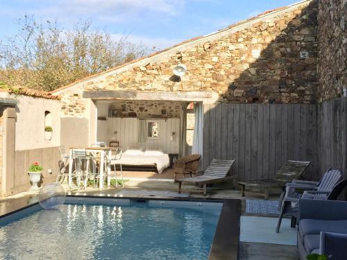a house with a swimming pool next to a bedroom at Gites De L'Etang Des Noues in Cholet