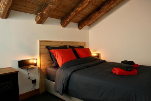 a bedroom with a large bed with red pillows at La Pieuca in Les Contamines-Montjoie