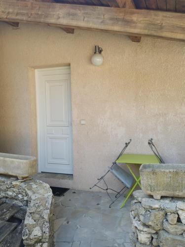 a room with a door and a table in front of a wall at La Maison St Gervais in Saint-Gervais