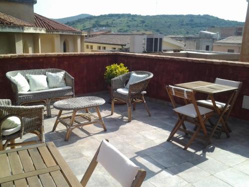 a group of chairs and tables on a patio at Hotel Sa Cralla Villasimius in Villasimius