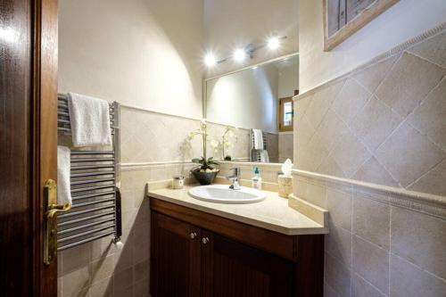 a bathroom with a sink and a mirror at Nice villa Marpessa in Portals Nous with pool in Portals Nous