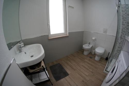 a bathroom with a sink and a toilet at Costantino Home in Pompei