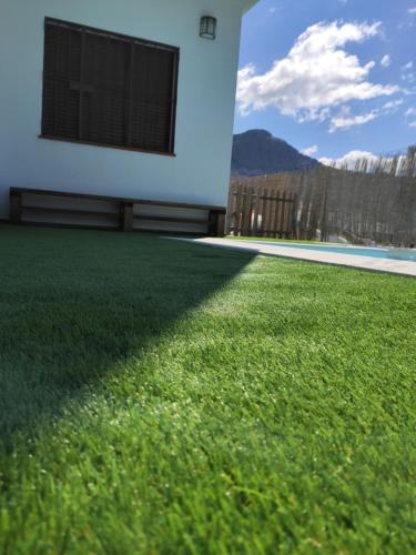 a house with a yard with green grass at La Atalaya in Benaocaz